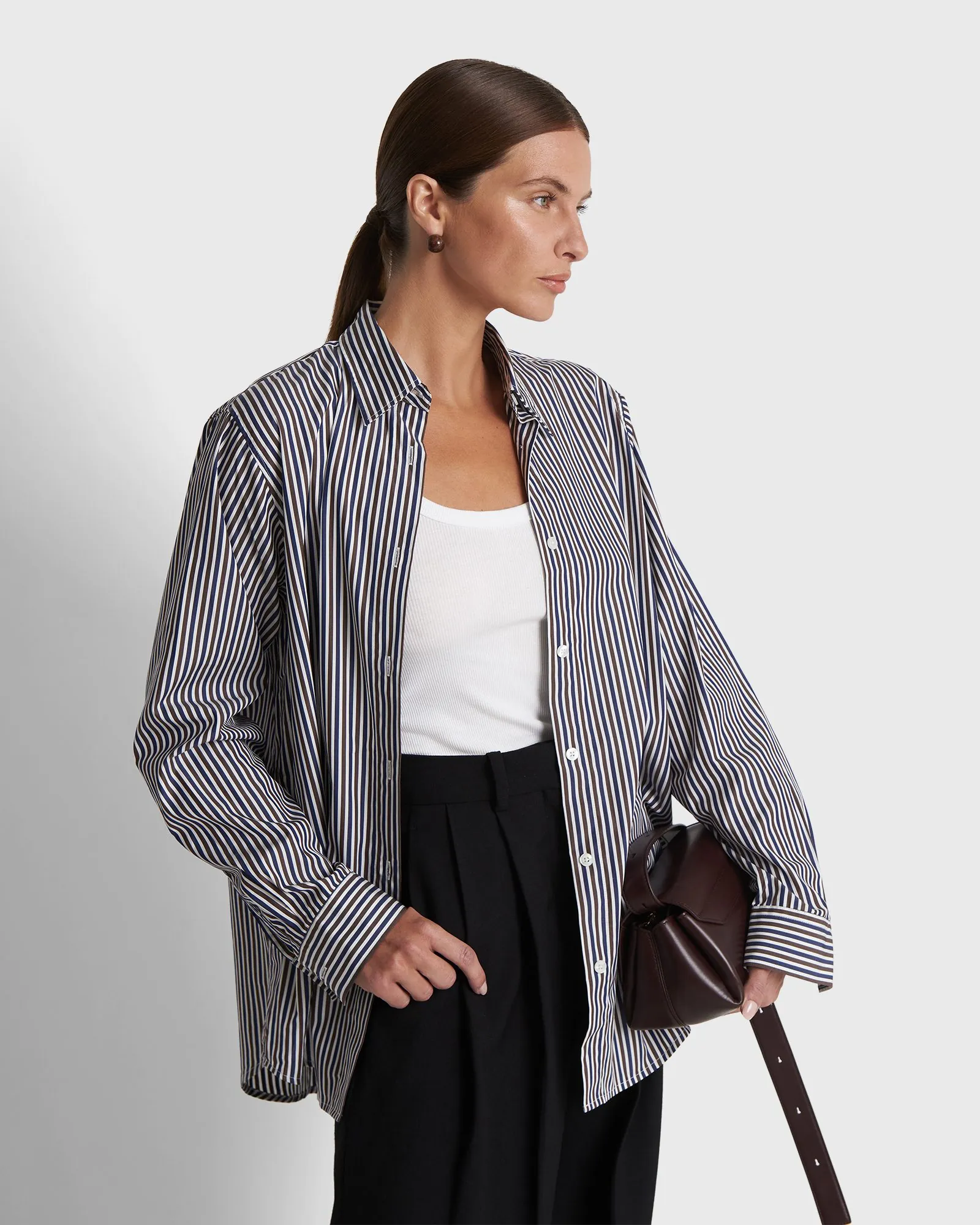 Styled womenswear look, striped shirt and tailored trousers