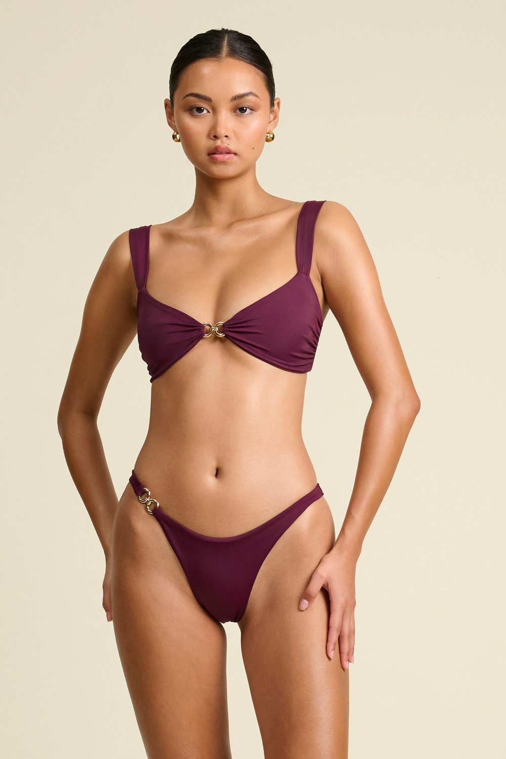 Away That Day plum bikini with gold chain hardware, on model