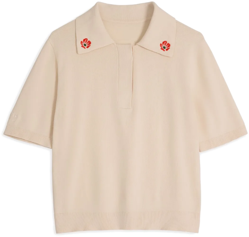 Cream floral embroidered polo shirt flat lay photography