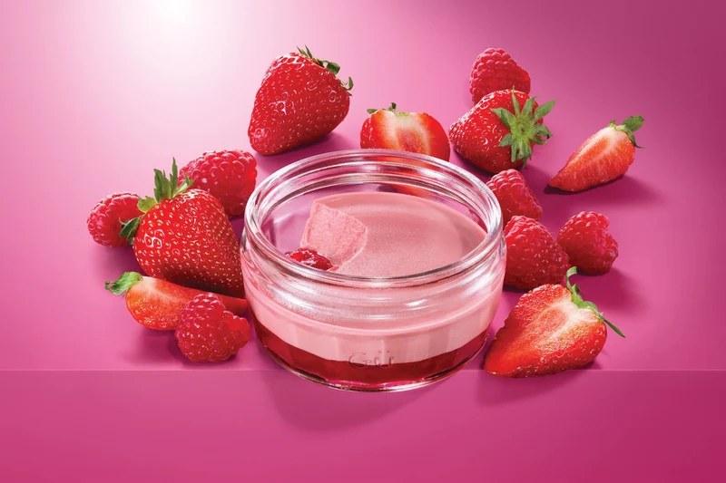 Gü strawberry and raspberry dessert in a glass ramekin with berries