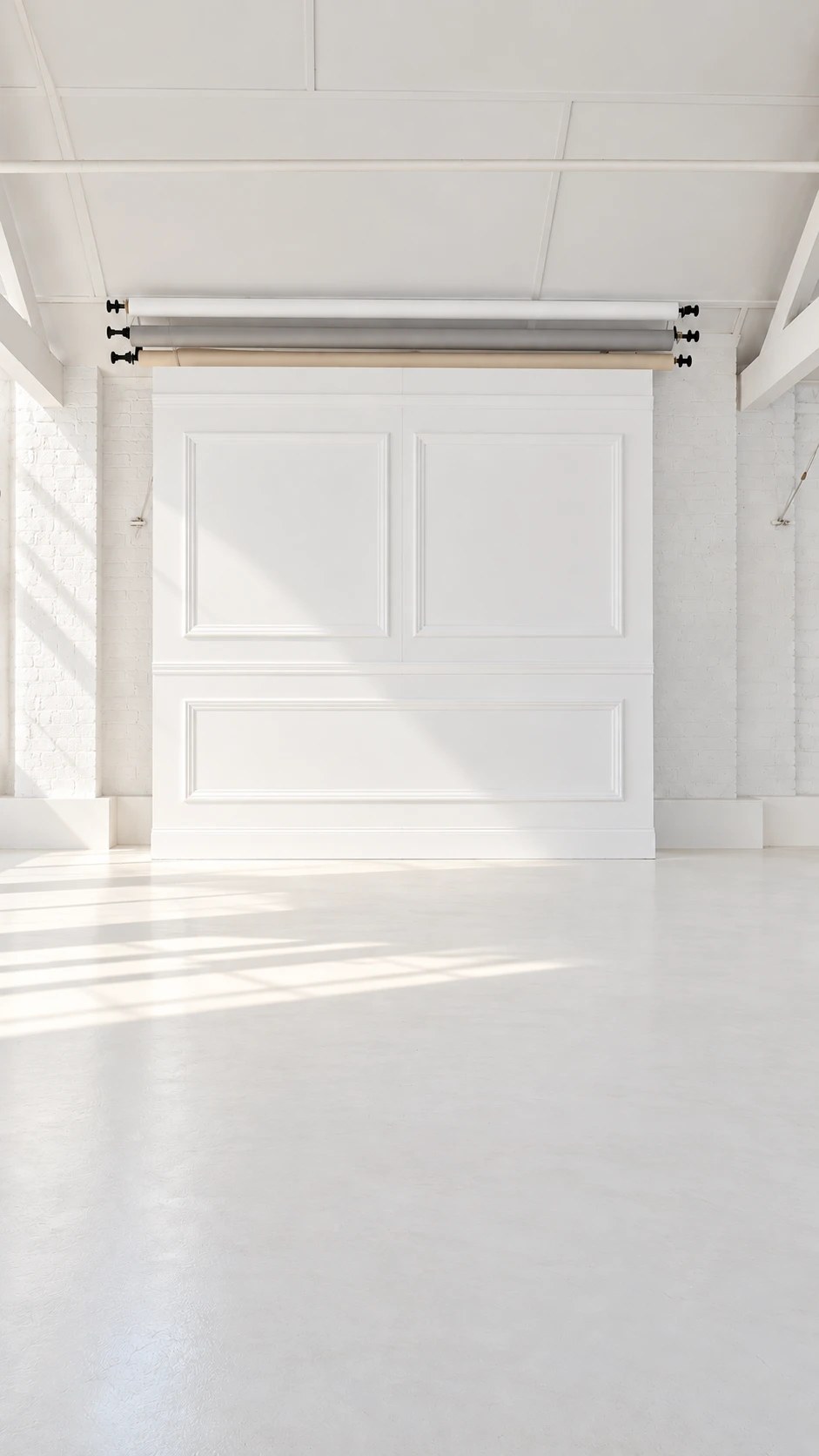 White panelled backdrop hire in London at Motherlight Studios, with paper backdrop rolls above