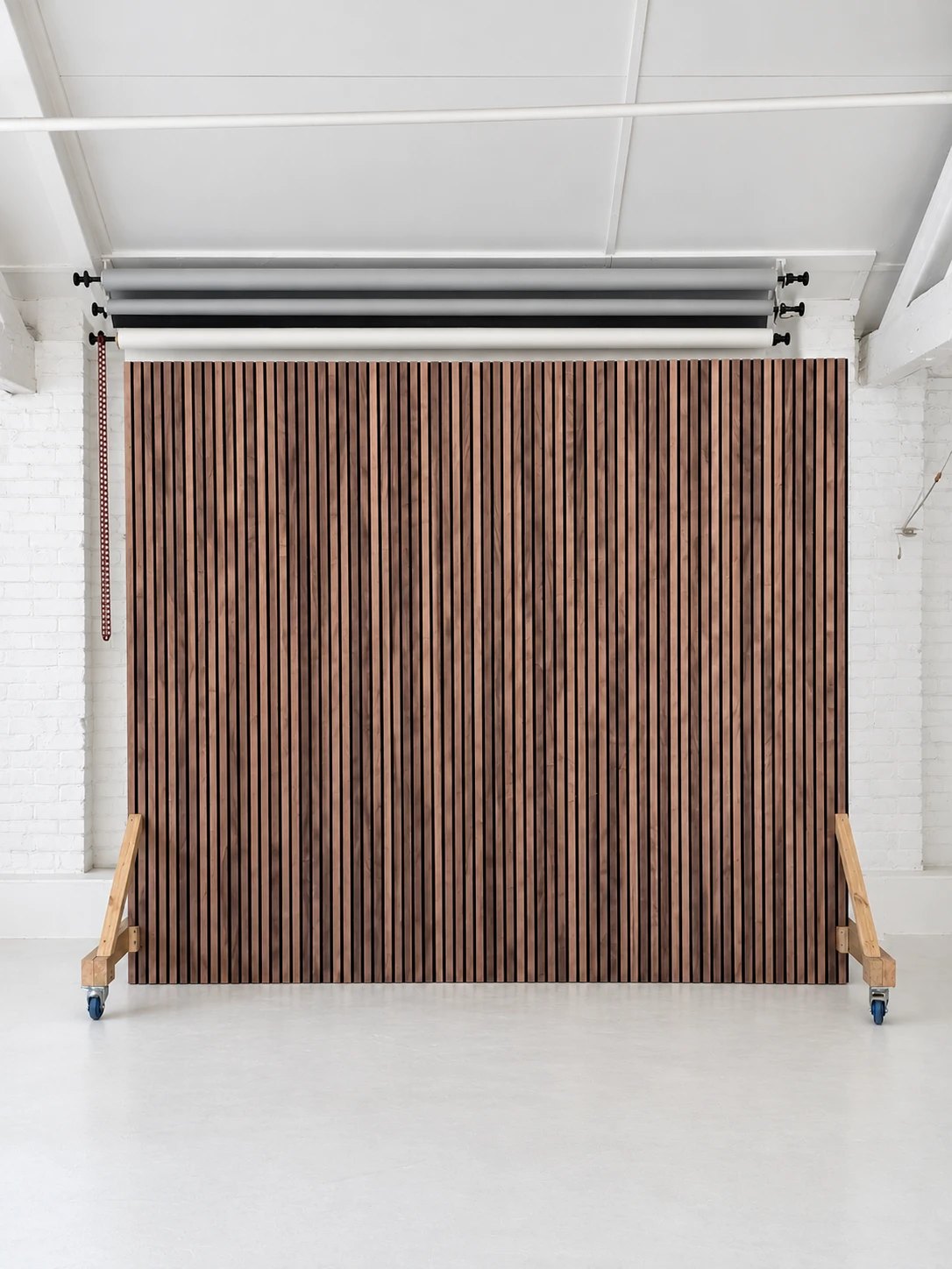 Walnut slatted wood backdrop on castors under the paper backdrop rolls at Motherlight Studios